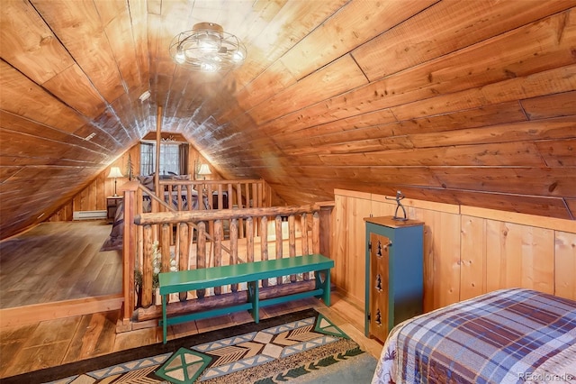 bedroom with light wood-type flooring, wood walls, vaulted ceiling, and wooden ceiling