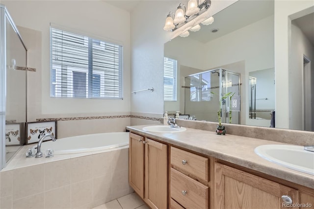 bathroom with shower with separate bathtub, tile patterned floors, and vanity