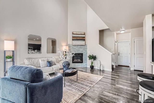 3611 S Perth Cir Unit 103, Aurora, CO 80013 - living area with a glass covered fireplace, wood finished floors, and a high ceiling