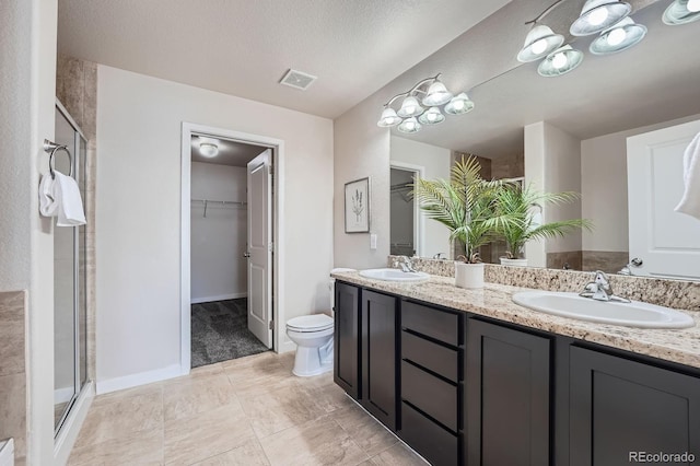 3611 S Perth Cir Unit 103, Aurora, CO 80013 - bathroom with a spacious closet, double vanity, and a stall shower