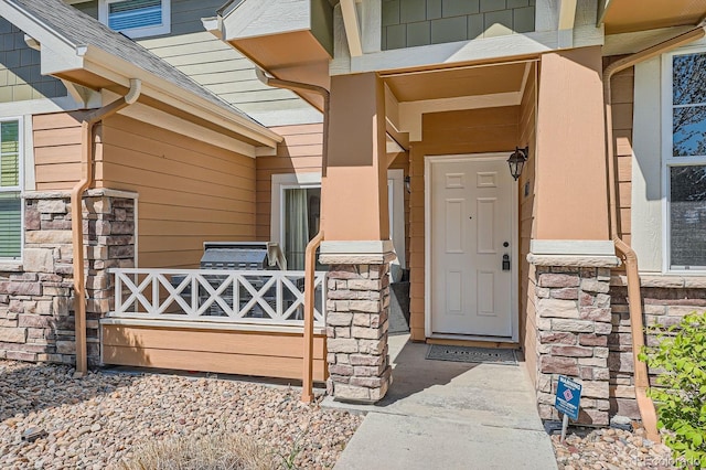 3611 S Perth Cir Unit 103, Aurora, CO 80013 - entrance to property featuring stone siding and a shingled roof