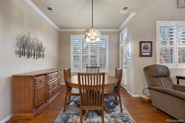 dining room featuring wood-type flooring, a notable chandelier, and ornamental molding