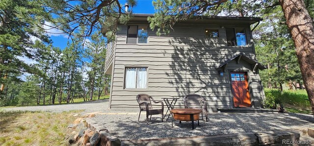 27901 Pine Dr, Evergreen, CO 80439 - rear view of house featuring a fire pit