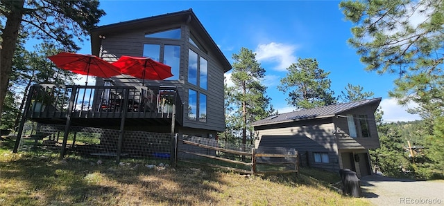 27901 Pine Dr, Evergreen, CO 80439 - view of property exterior with a wooden deck and a metal roof