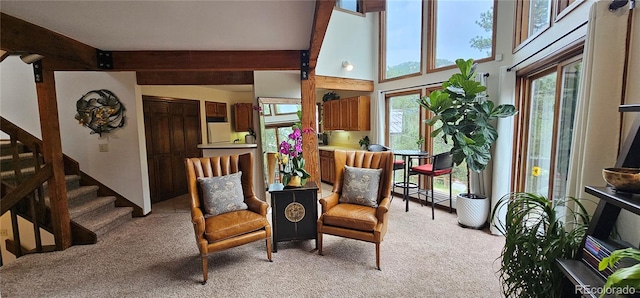 27901 Pine Dr, Evergreen, CO 80439 - living area with light carpet, beam ceiling, and stairs