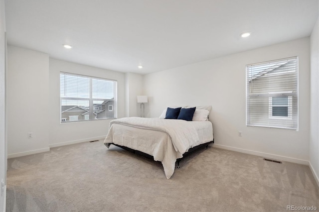 bedroom featuring light carpet