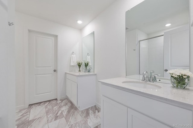 bathroom featuring vanity and an enclosed shower