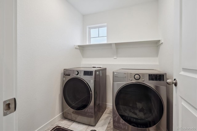 clothes washing area with washing machine and dryer