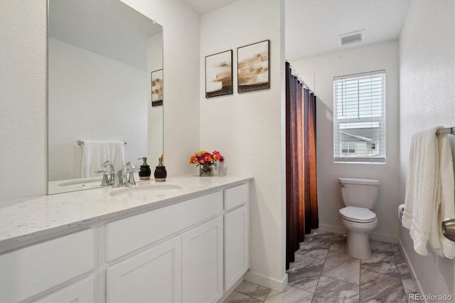 bathroom featuring vanity and toilet