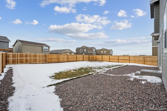 view of yard layered in snow