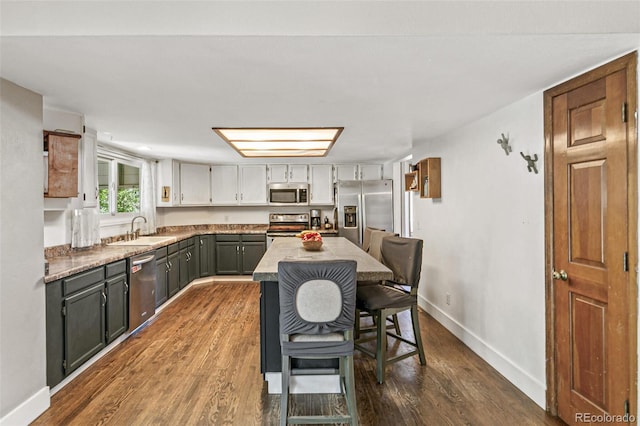 kitchen featuring gray cabinetry, sink, appliances with stainless steel finishes, and dark wood-type flooring