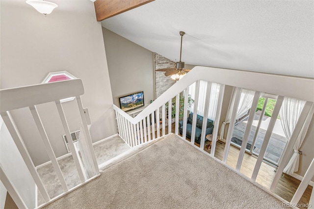 stairs featuring carpet and vaulted ceiling with beams