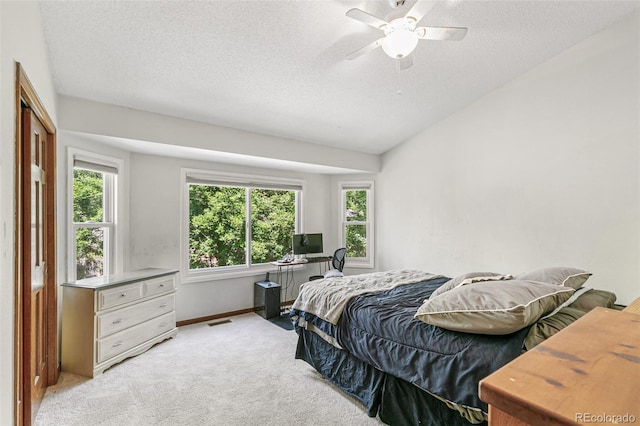 bedroom featuring light carpet, a textured ceiling, ceiling fan, and lofted ceiling