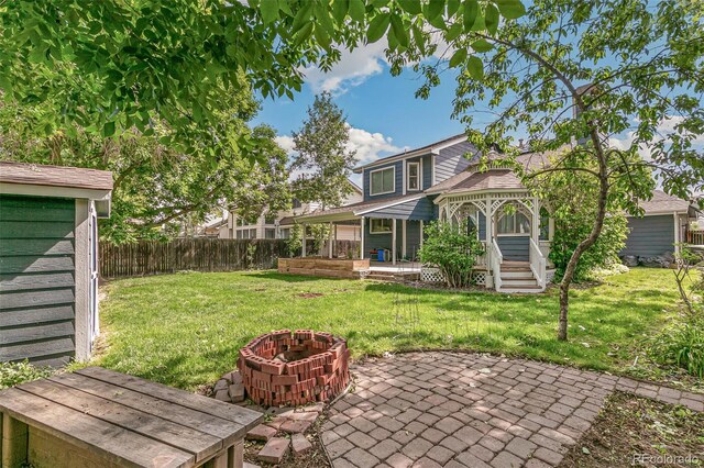 back of house featuring a patio area and a yard