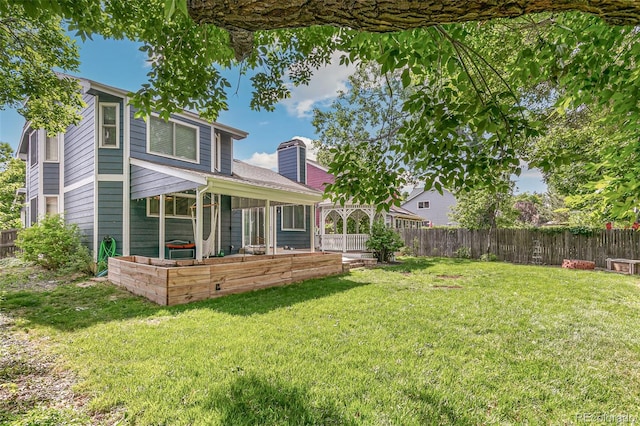 rear view of property with a lawn