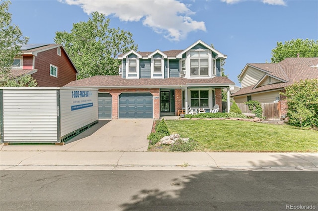 view of front of property featuring a garage, a porch, and a front yard