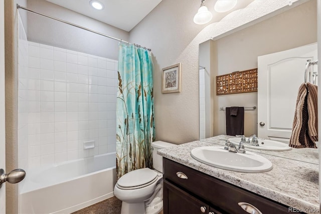 full bathroom featuring shower / bath combo with shower curtain, vanity, tile patterned flooring, and toilet