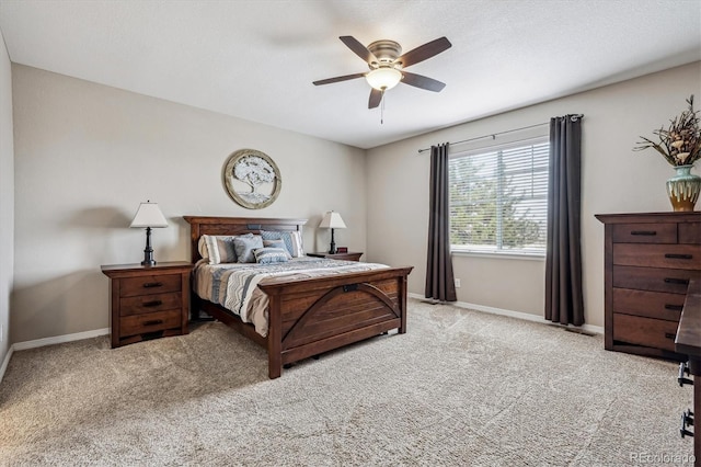 bedroom with ceiling fan, baseboards, light carpet, and a textured ceiling