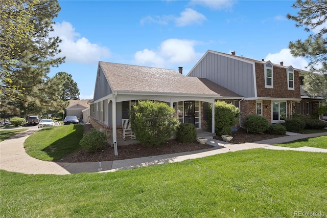 2608 E Fremont Pl, Centennial, CO 80122 - view of front facade with a front yard, roof with shingles, and brick siding