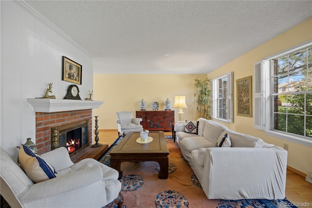 2608 E Fremont Pl, Centennial, CO 80122 - living room with a textured ceiling, plenty of natural light, a fireplace, wood finished floors, and crown molding