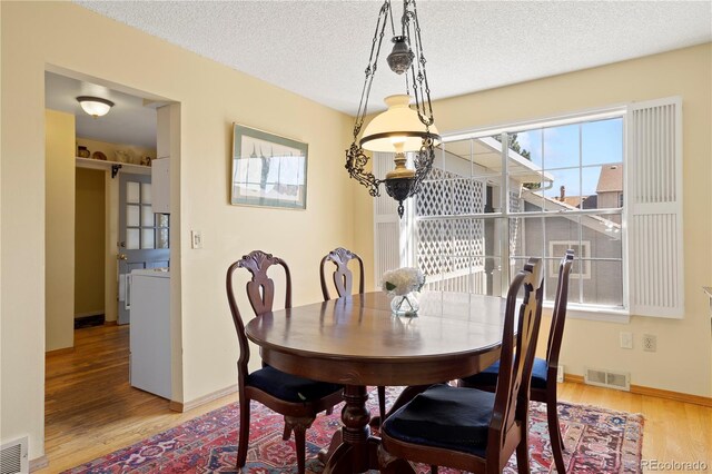 2608 E Fremont Pl, Centennial, CO 80122 - dining room featuring plenty of natural light, wood finished floors, baseboards, and a textured ceiling
