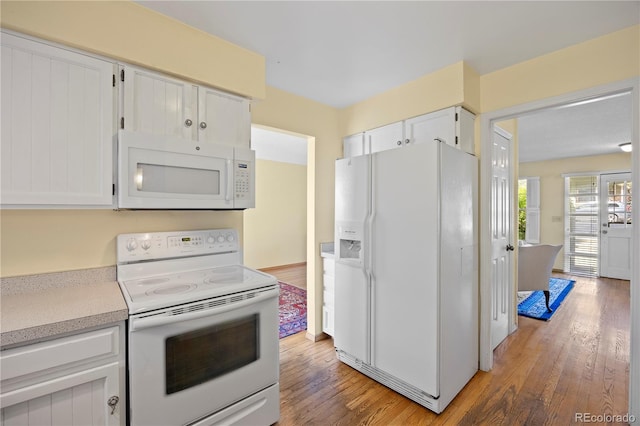 2608 E Fremont Pl, Centennial, CO 80122 - kitchen featuring white appliances, light wood-type flooring, white cabinetry, and light countertops