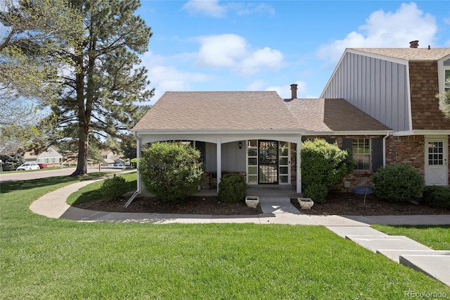 2608 E Fremont Pl, Centennial, CO 80122 - view of front facade with a front yard, roof with shingles, a porch, brick siding, and a chimney