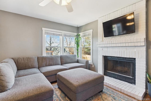 living room featuring a fireplace, hardwood / wood-style floors, and ceiling fan