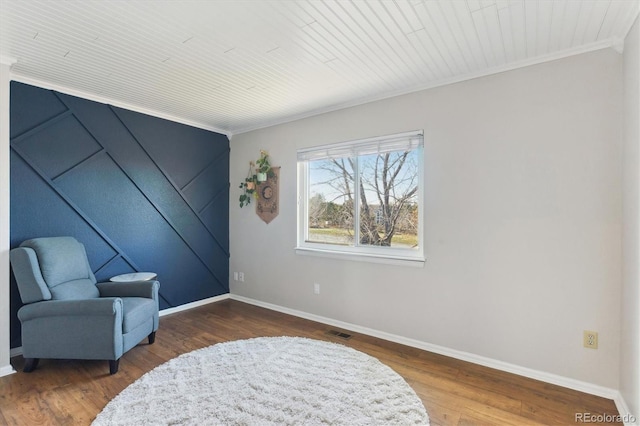 sitting room with hardwood / wood-style flooring and ornamental molding