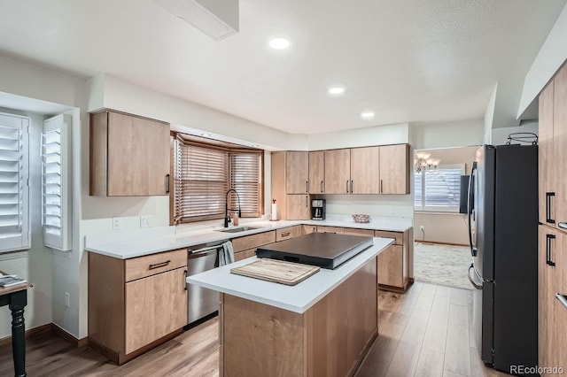 11759 E Asbury Ave, Aurora, CO 80014 - kitchen with stainless steel appliances, light wood-style floors, a center island, light countertops, and recessed lighting