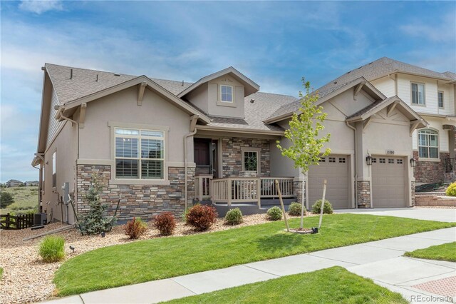 view of front of property with stone siding, stucco siding, driveway, and central air condition unit