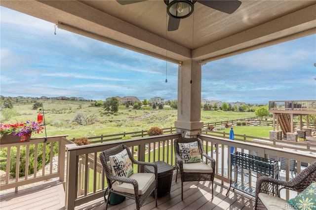 deck with a ceiling fan and a view of rural / pastoral area