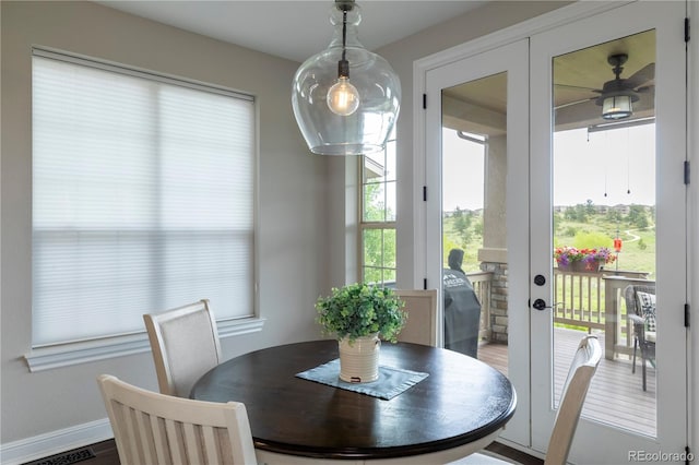 dining area with a ceiling fan, french doors, baseboards, and wood finished floors