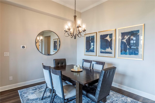 dining area featuring a chandelier, baseboards, wood finished floors, and crown molding
