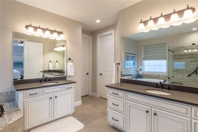 bathroom featuring a shower stall, a garden tub, two vanities, and recessed lighting