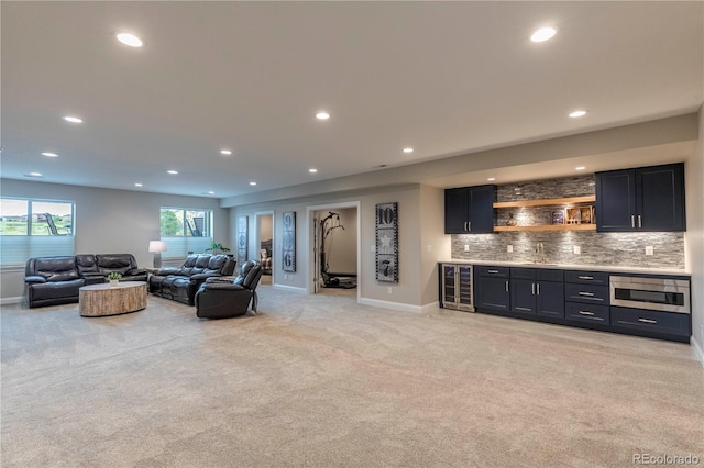 living area with wine cooler, wet bar, light colored carpet, baseboards, and recessed lighting