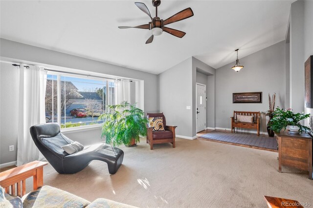 sitting room featuring ceiling fan, carpet, vaulted ceiling, and baseboards
