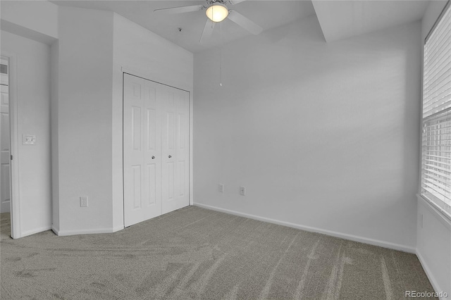 unfurnished bedroom with carpet, ceiling fan, and a closet