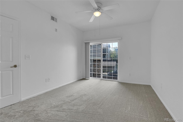 carpeted spare room featuring ceiling fan