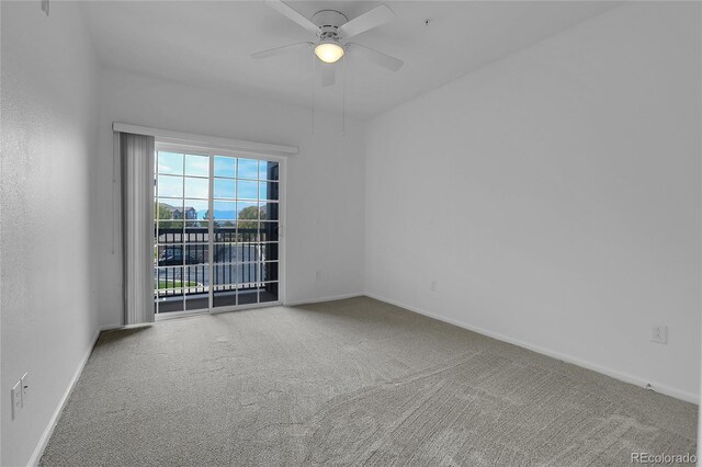 spare room with ceiling fan and carpet