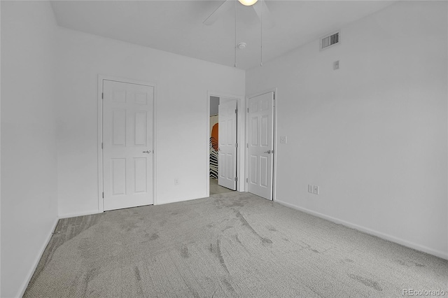 unfurnished bedroom with light carpet and ceiling fan