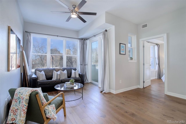 living room featuring ceiling fan and light wood-type flooring