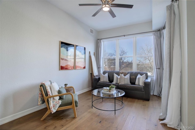 living room featuring light hardwood / wood-style floors and ceiling fan