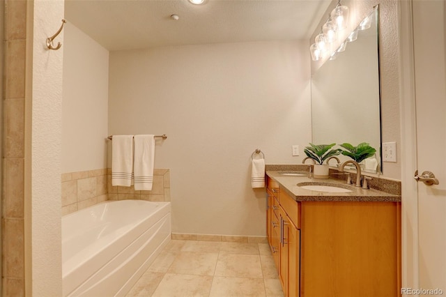 bathroom with tile patterned floors, vanity, and a tub