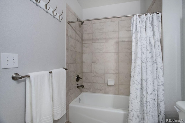 bathroom with toilet and shower / bath combo with shower curtain