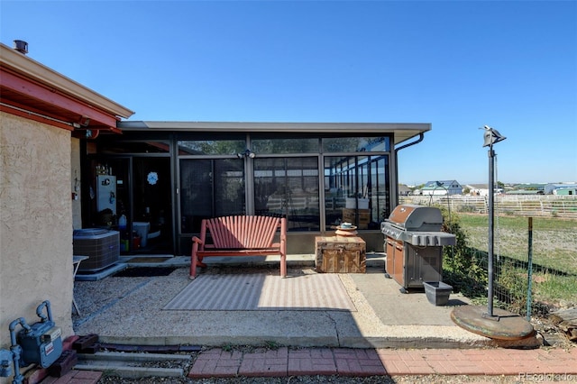 view of patio / terrace featuring a sunroom and central air condition unit