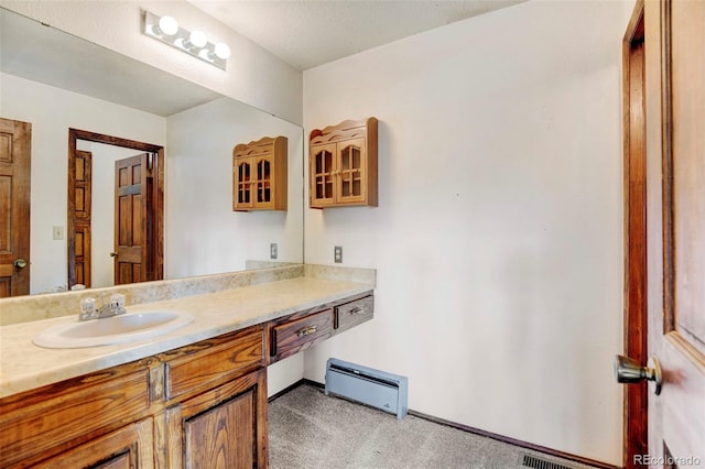 bathroom with vanity and a baseboard heating unit