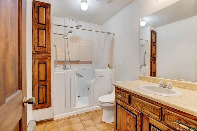 full bathroom with vanity, a baseboard radiator, tile patterned floors, toilet, and shower / bath combo with shower curtain