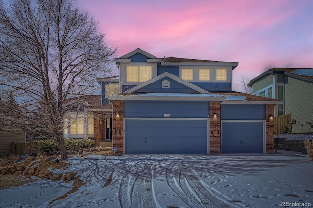 traditional home with a garage and brick siding