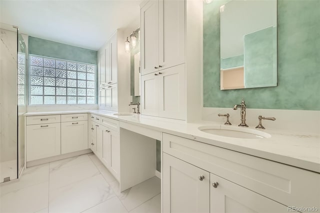 bathroom with marble finish floor, a sink, and double vanity